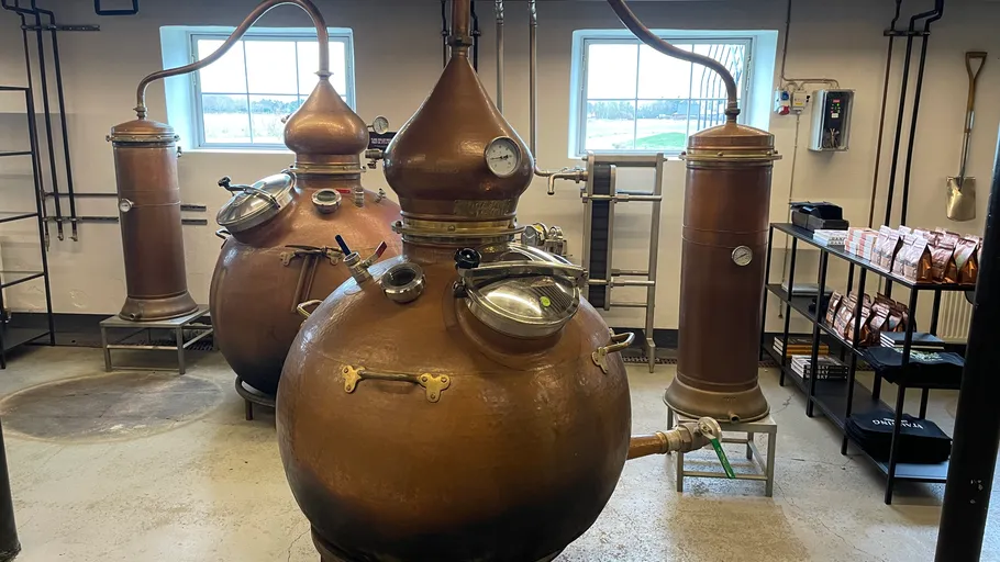 Copper distillery equipment in a workshop.