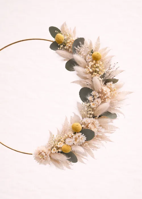 Floral wreath with yellow and white flowers.