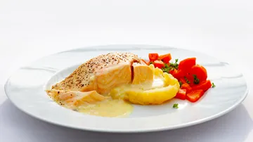 Salmon with mashed potatoes and carrots on plate.