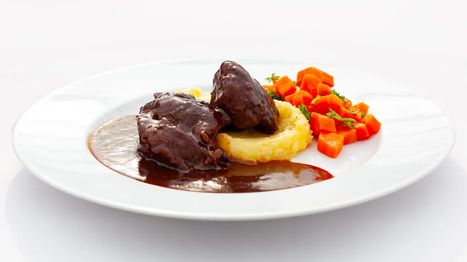 Beef in sauce with mashed potatoes, carrots.