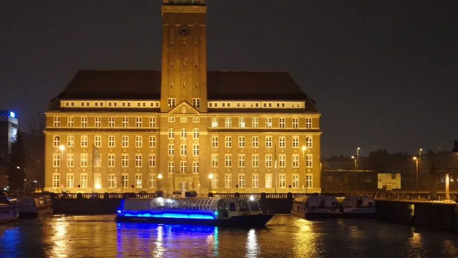 Illuminated building and boat at night.