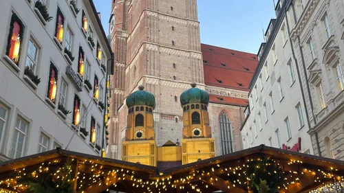 Church tower and festive market scene.