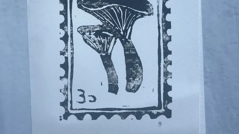 Black mushroom illustration on white stamp.