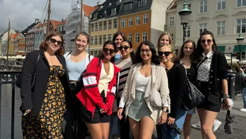 Group of people posing in a city street.