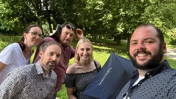 Group of five people in a park.