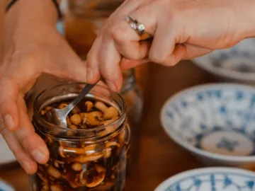 A glass is filled with a spoon to serve food.