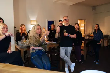 Group of people conversing in a cozy bar.