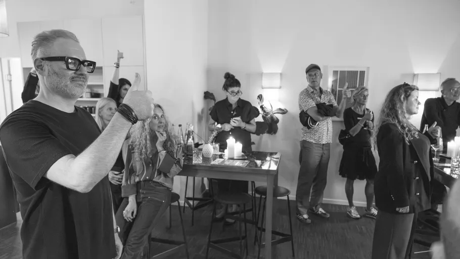 Man giving thumbs-up at a casual gathering.