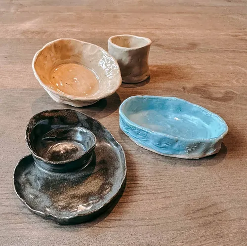 Handmade pottery on a wooden table.