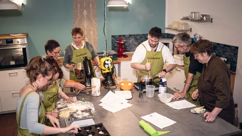 Group cooking in a modern kitchen.