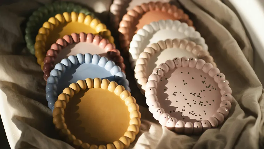 Colorful ceramic plates with scalloped edges.
