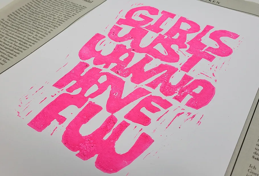 Pink text on a white background with newspaper.