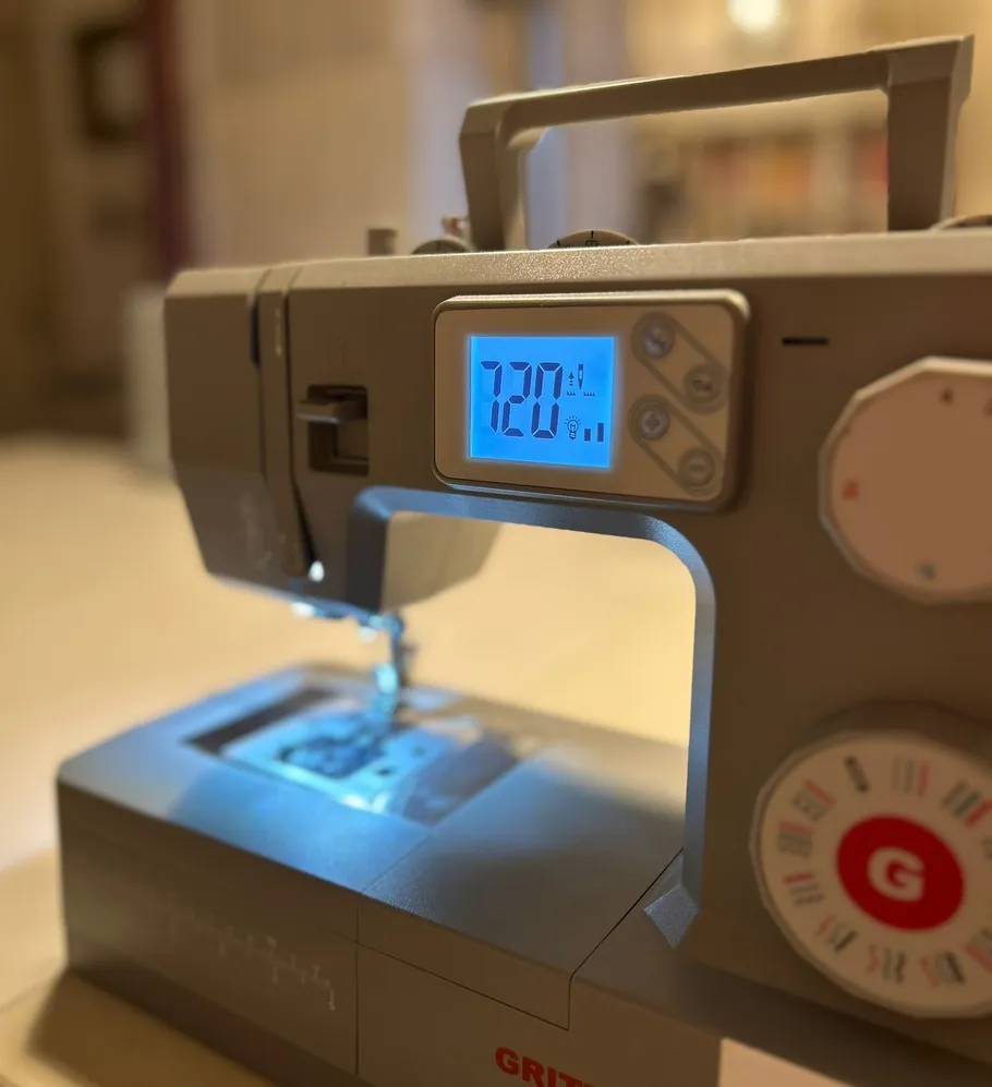 Sewing machine with digital display, indoors.
