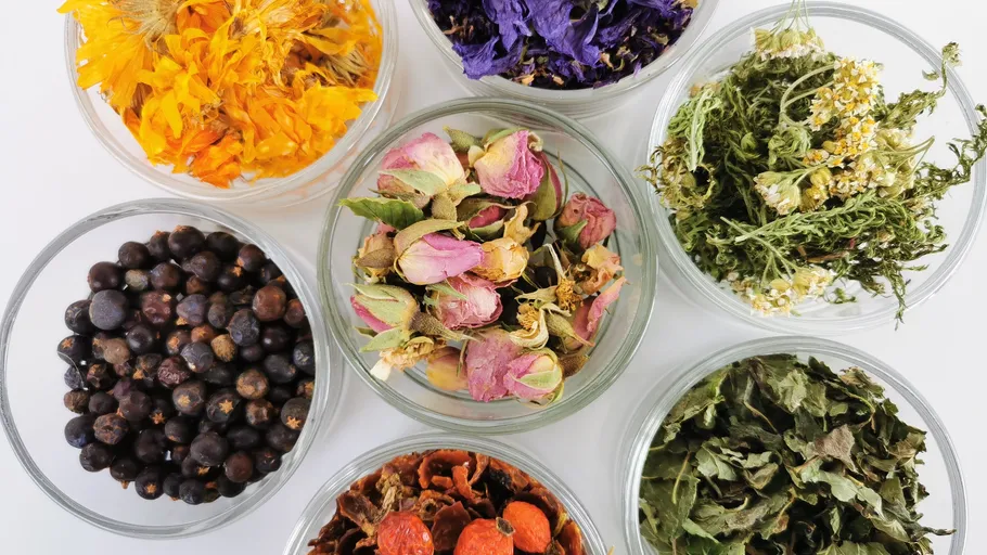 Various dried herbs displayed in glass bowls.