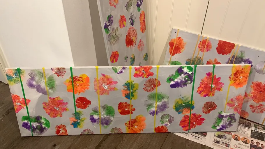 Colorful flower paintings on wooden floor.