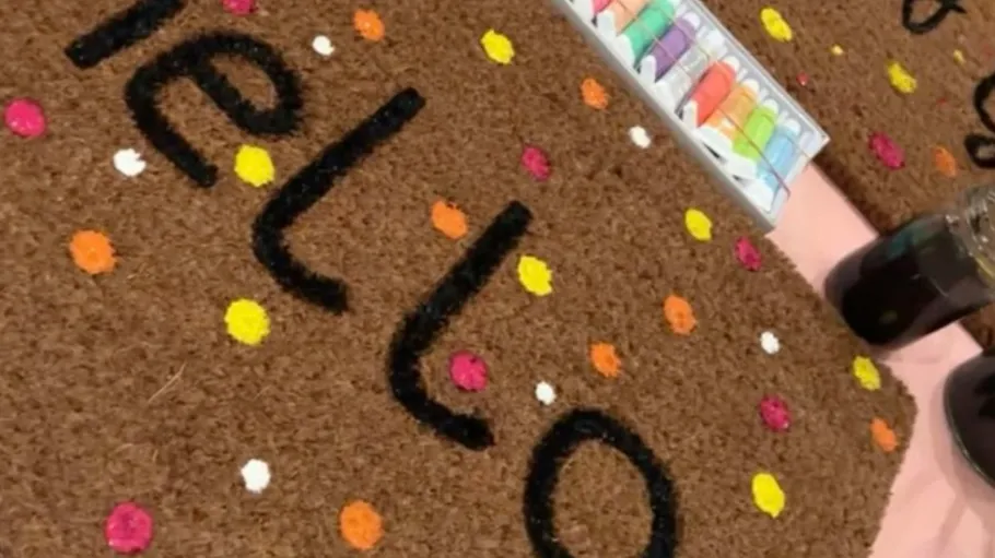 Colorful doormat with 'hello' and dots.
