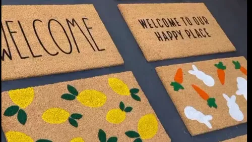 Four door mats with various designs on display.