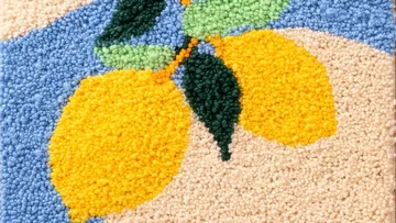 Textured lemons pattern on a woven fabric.