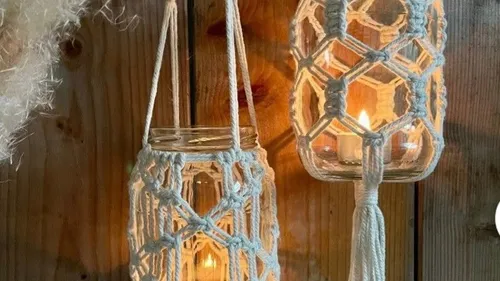 Hanging glass jars with macramé rope covers.