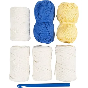 Yarn and crochet hook on white background.