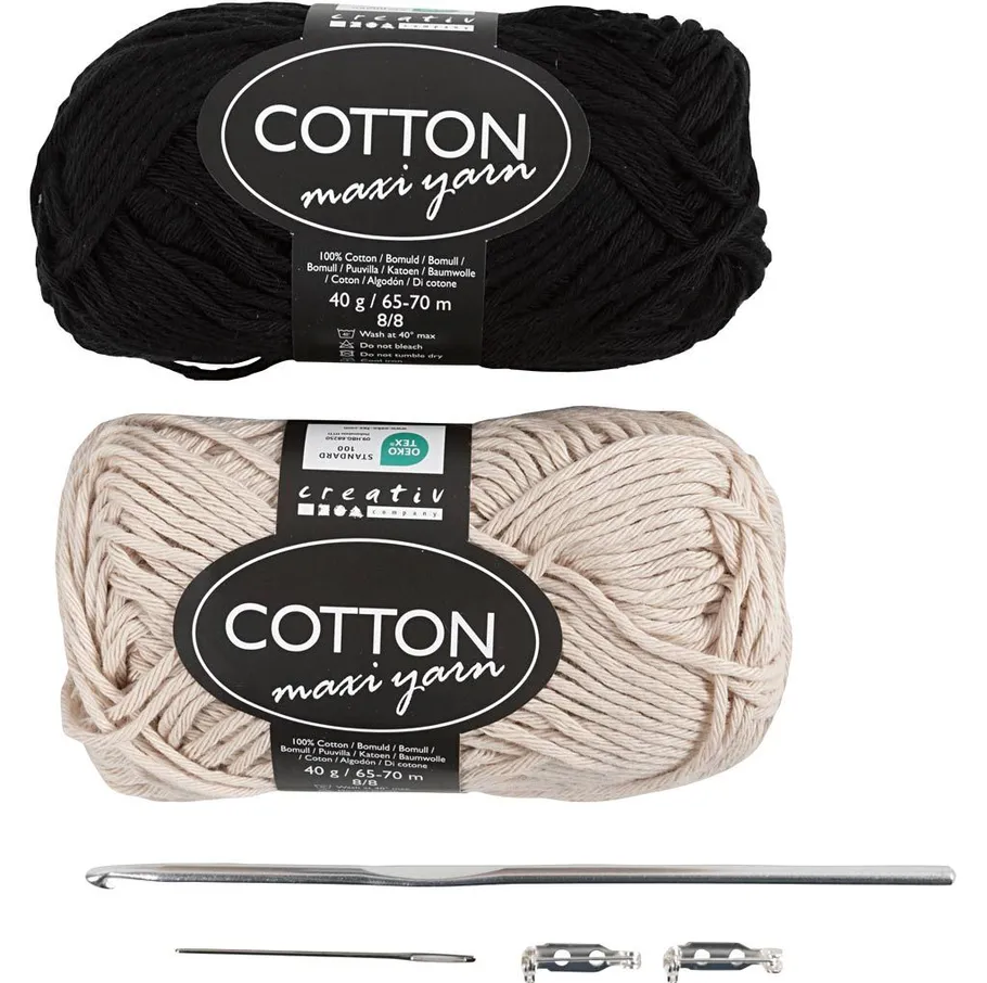 Black and beige yarn with crochet hook.