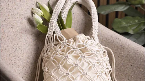 Macrame bag with tulips on a chair.