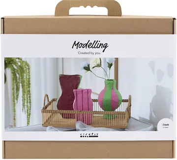 Box with modeling clay and vase examples.