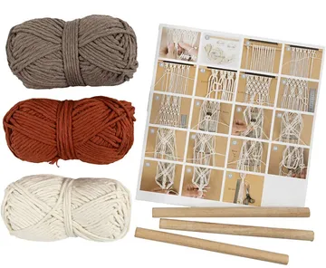 Yarn bundles, macrame instructions, and wooden rods.