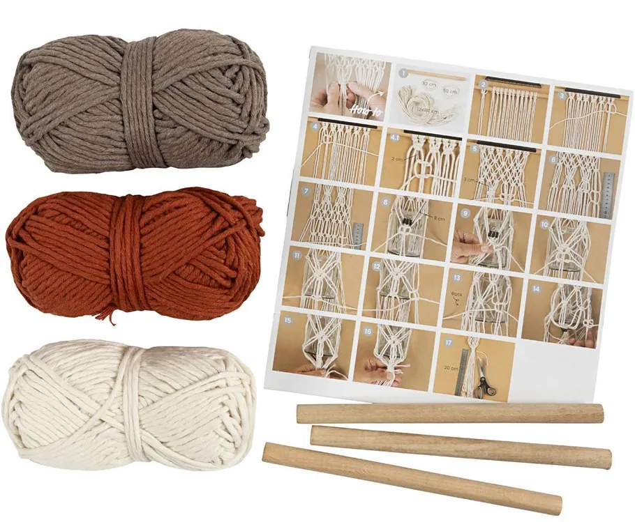 Yarn bundles, macrame instructions, and wooden rods.