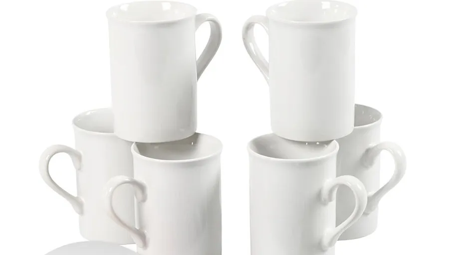 Six white ceramic mugs stacked orderly.