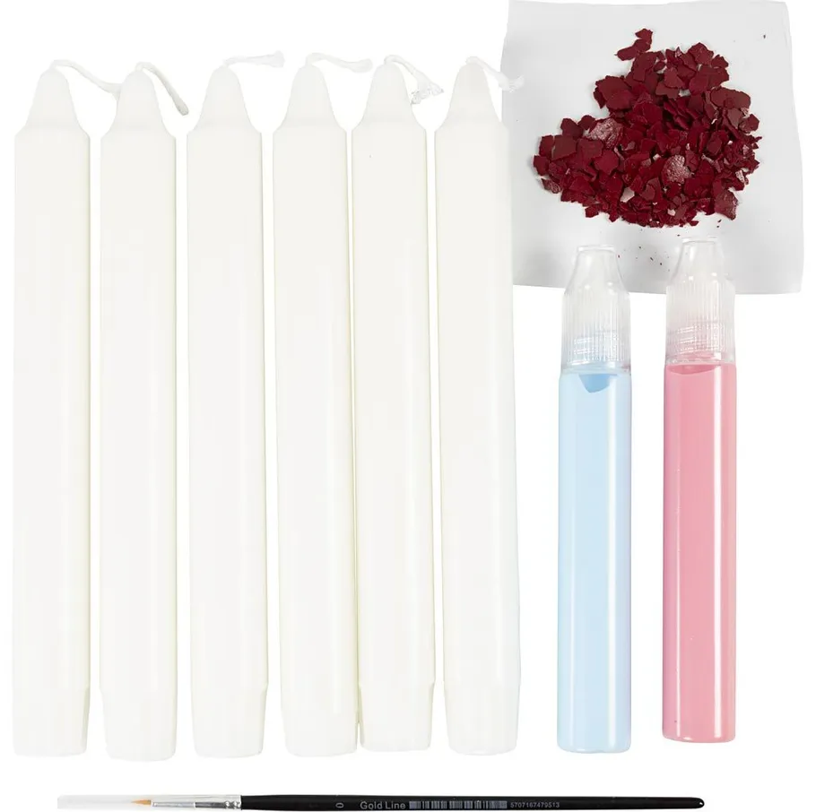 White candles with paint tubes and brush.