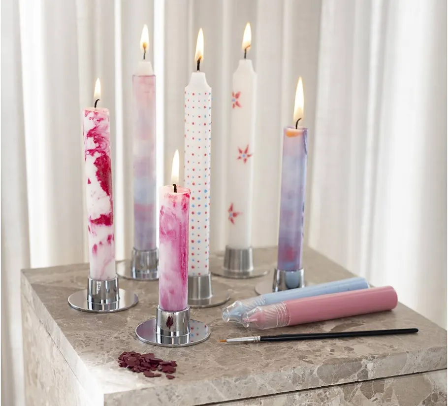 Decorative candles lit on a marble table.