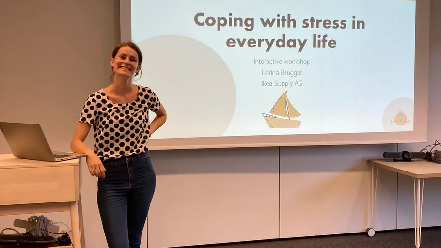Smiling woman presenting stress workshop slide.