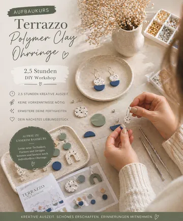 Hands crafting earrings, table with clay pieces.