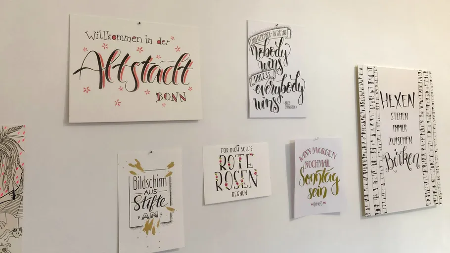 Wall displays various artistic typography posters.
