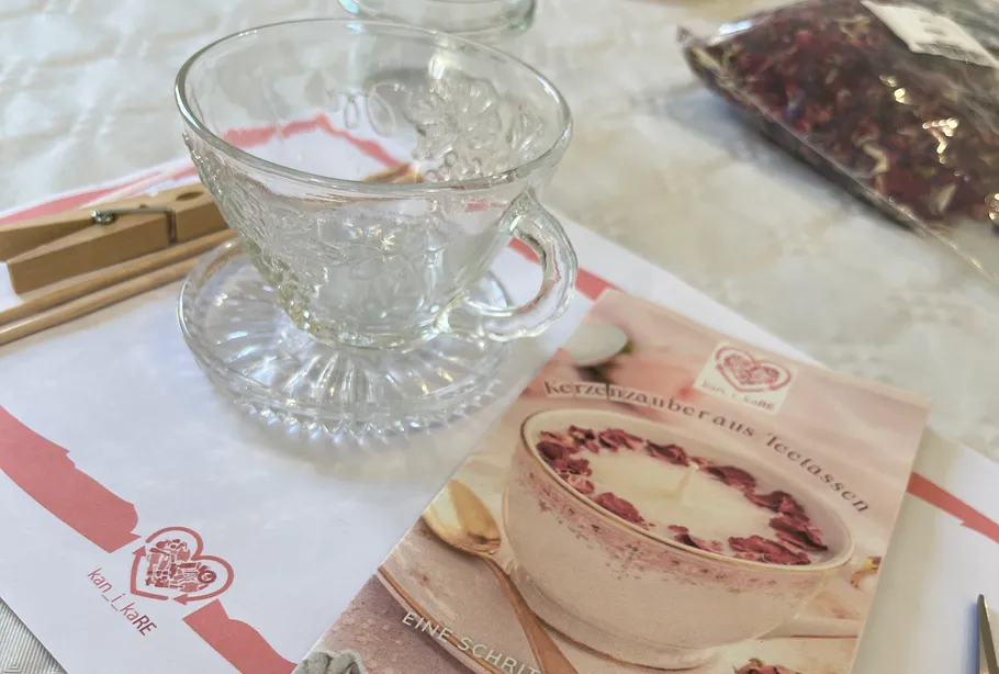 Glass teacup on a table with booklet.