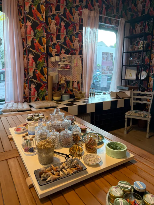 Craft room with bird wallpaper and jars.