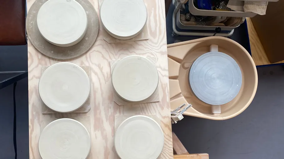 Circular clay pieces on a wooden table.