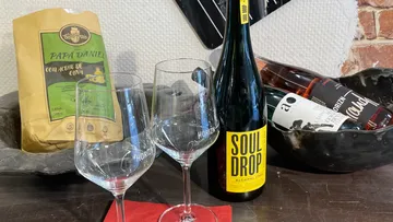 Wine glasses and bottles on a counter.