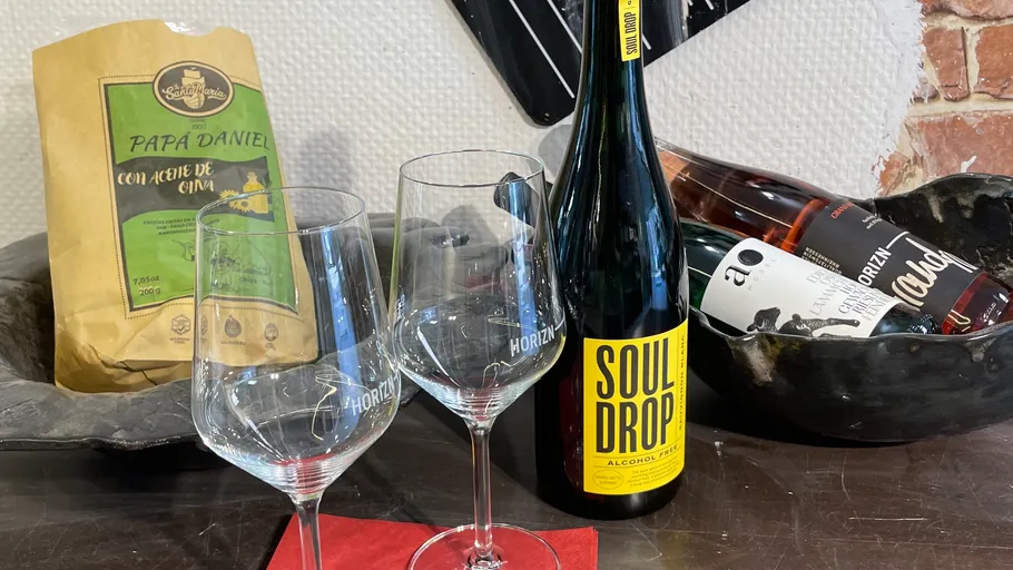 Wine glasses and bottles on a counter.