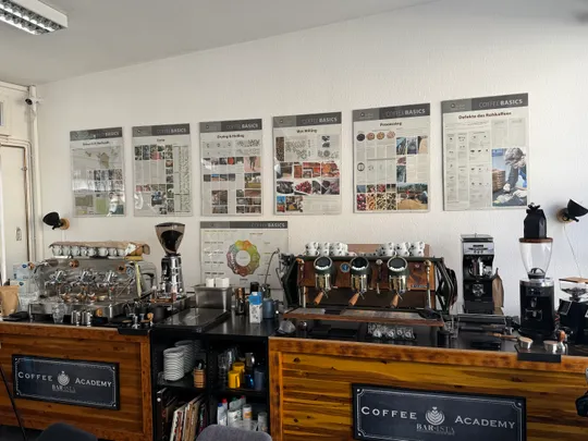 Coffee workshop with espresso machines and posters.