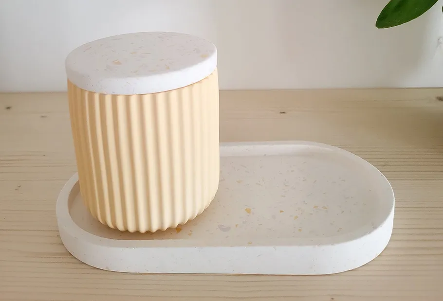 Ridged jar on a tray, wooden table.