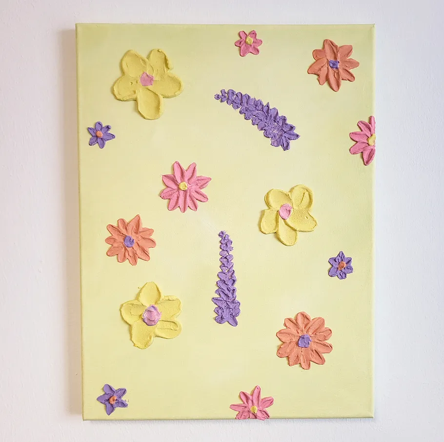 Canvas with colorful raised flowers design.