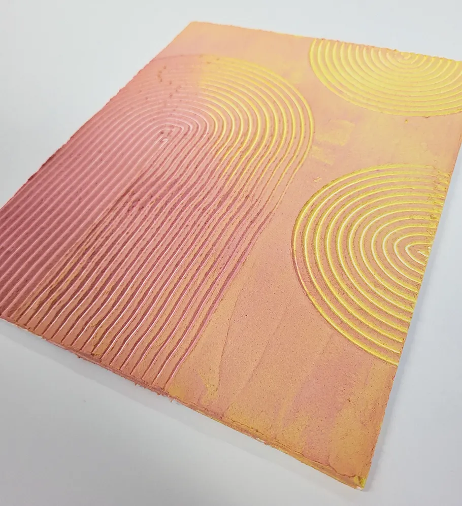 Textured artwork with concentric patterns on canvas.