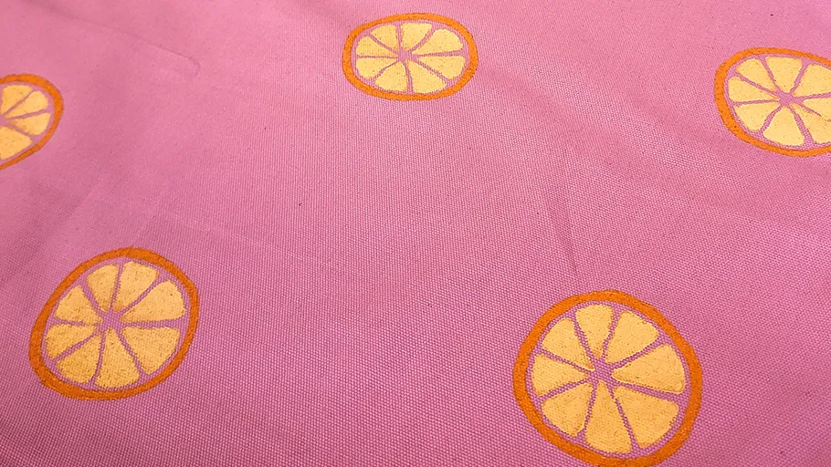 Yellow citrus prints on pink fabric.