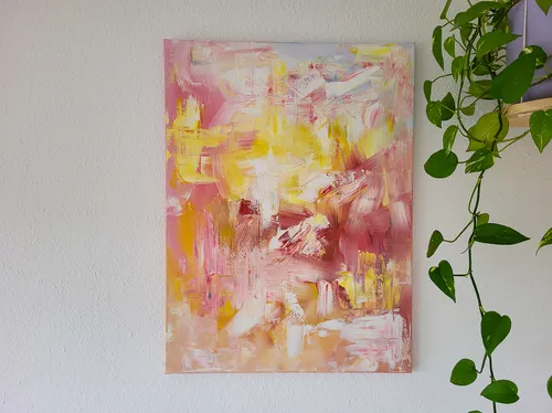 Abstract painting with pink and yellow tones.