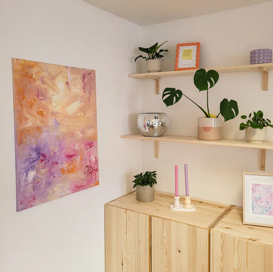 Colorful abstract painting on wall near shelves.