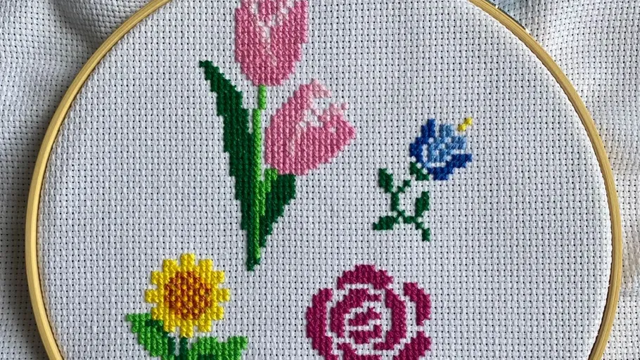 Cross-stitched flowers in an embroidery hoop.