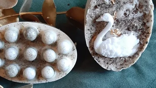 Decorative soaps with swan and sphere design.