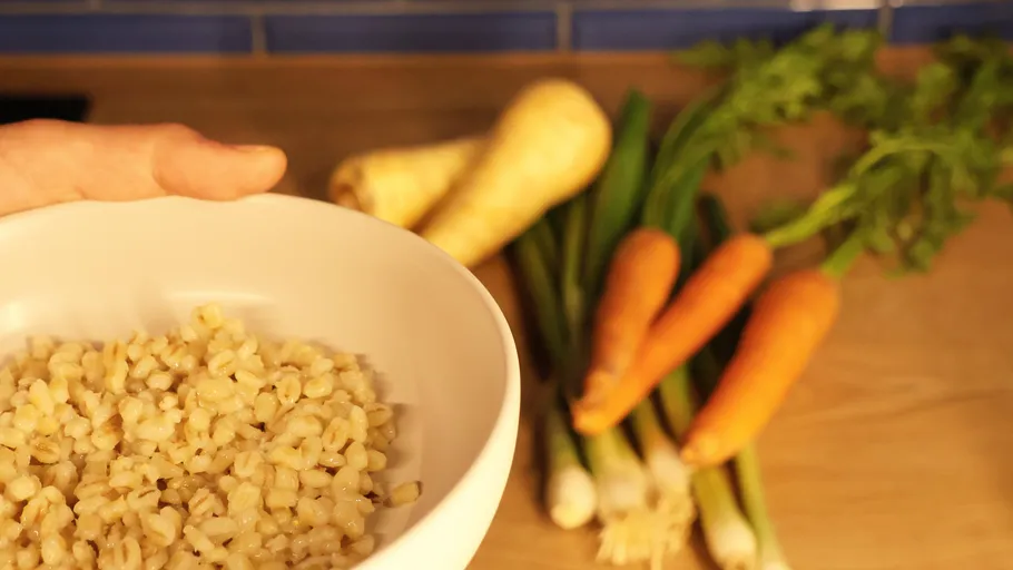 Bowl of grains with carrots and parsnips.